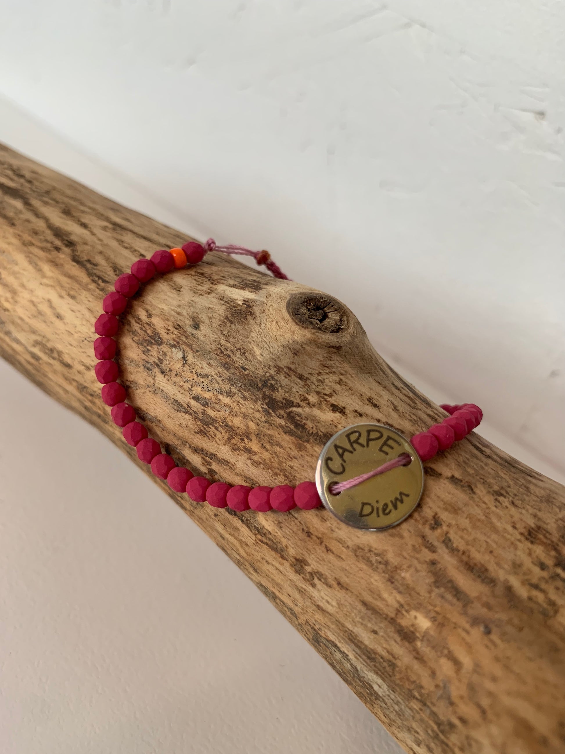 Détail du médaillon Carpe Diem sur bracelet rose mat